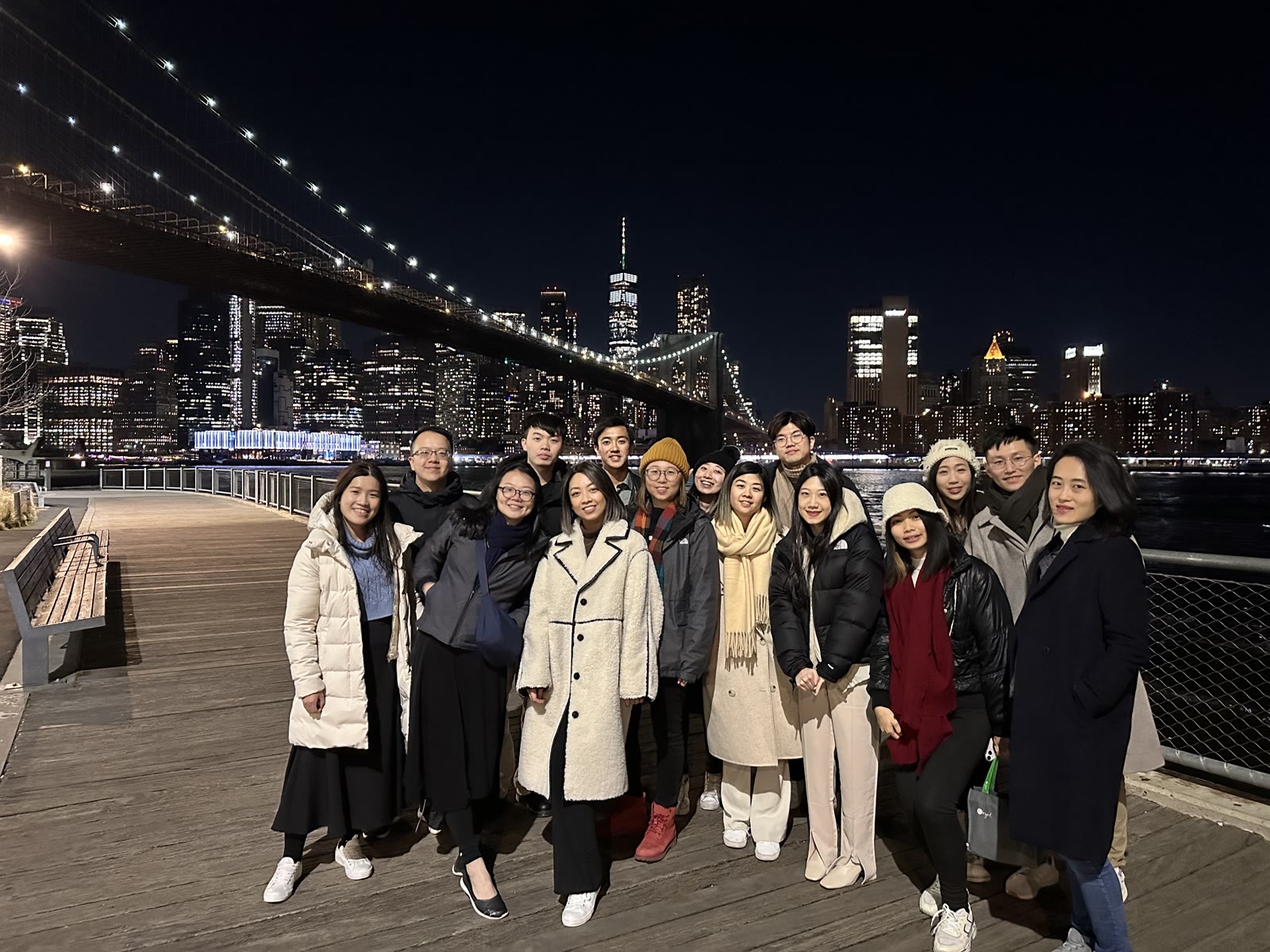 OST attendees in front of the Brooklyn Bridge at night